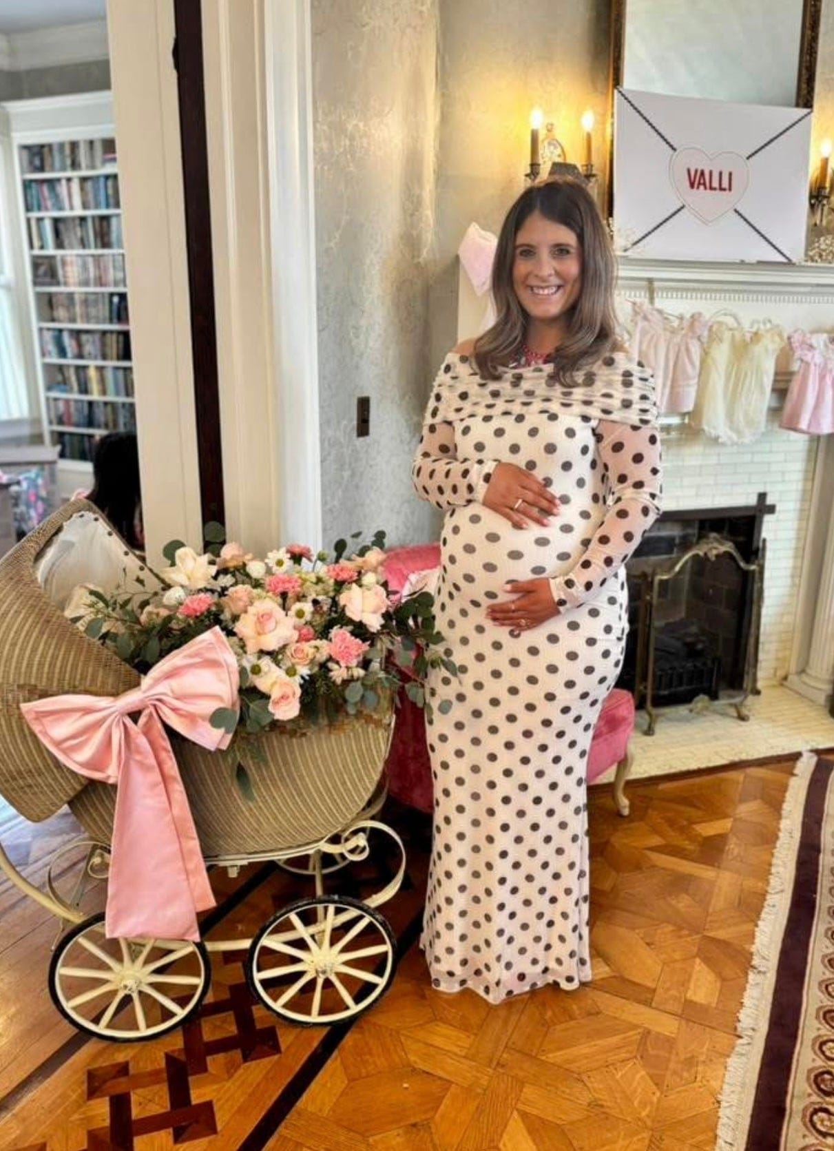 Pregnant lady celebrating her Baby Shower wearing Everything Lace Hire AFRM Thelma Green Dot Baby Shower Dress
