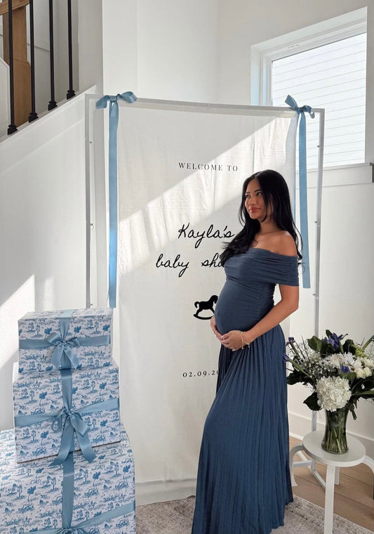 Pregnant mother celebrates her baby boy during her baby Shower wearing Everything Lace Hire Field of Dreams Baby Shower Dress in navy