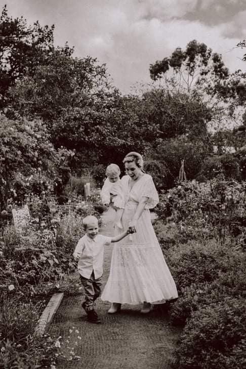 A mother during her motherhood photoshoot wearing Everything Lace Hire Alexandria Dress