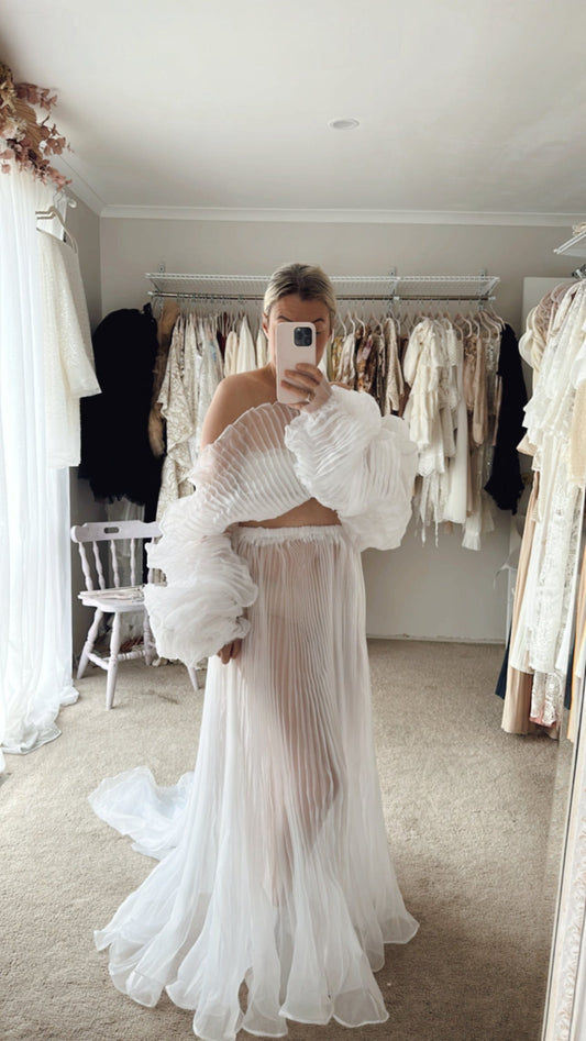 Lady wearing a crinkle white chiffon photoshoot set from Everything Lace Hire