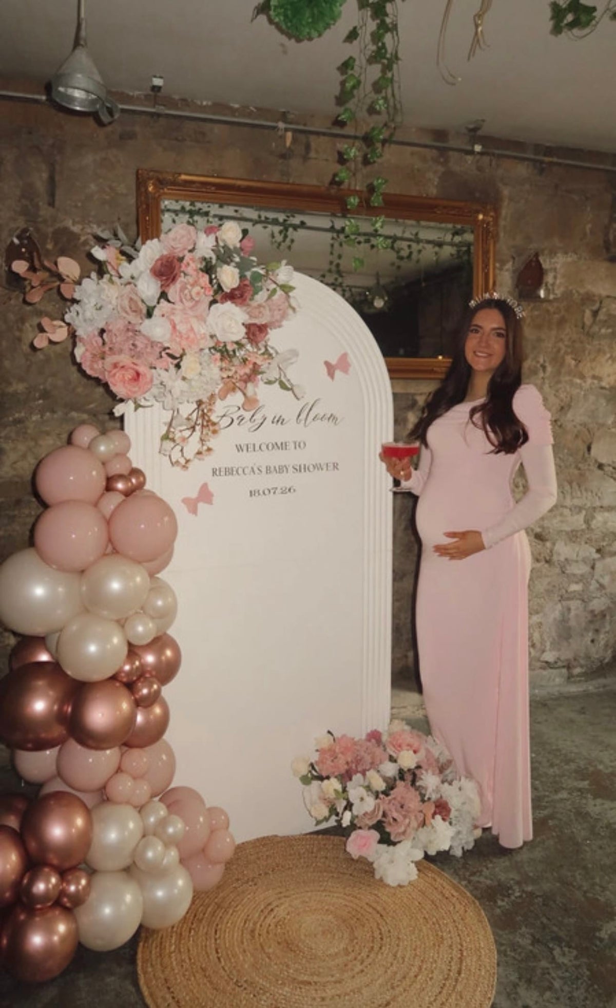 A pregnant woman is wearing Everything Lace Hire Club L London Amara pink dress for her Baby Shower