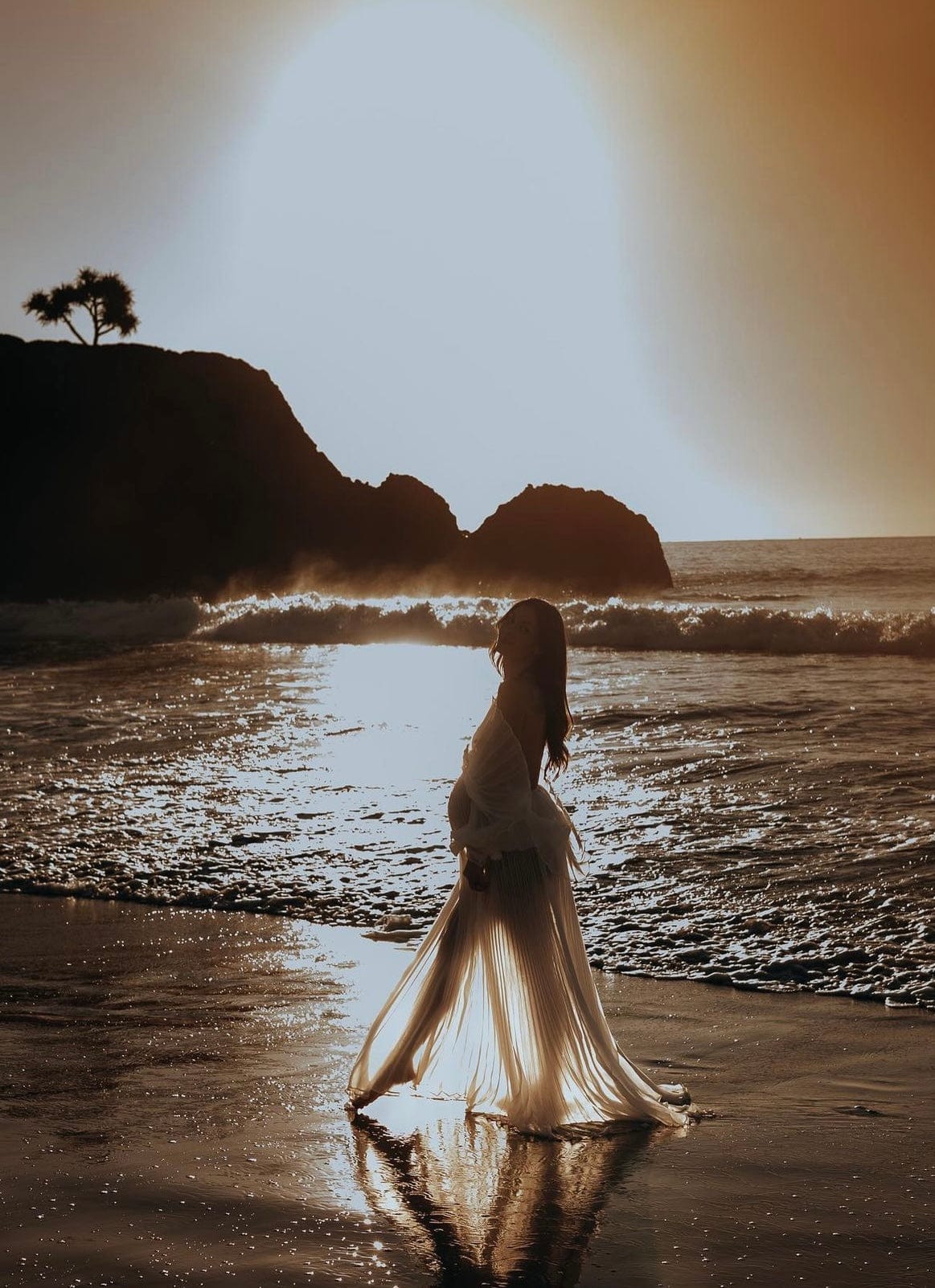 Beach maternity photoshoot at sunset wearing Everything Lace Hire Camille white maternity photoshoot dress in the sea