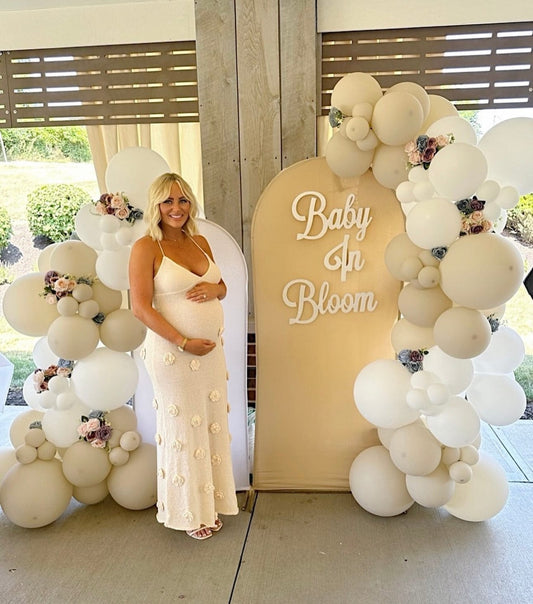 A pregnant lady wearing Everything Lace Hire Meshki Suki Blossom Dress during her Baby In Bloom Baby Shower