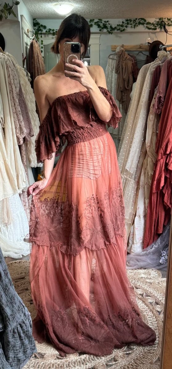 A stunning beautifully embroidered off the shoulder photoshoot dress in a rust colour 