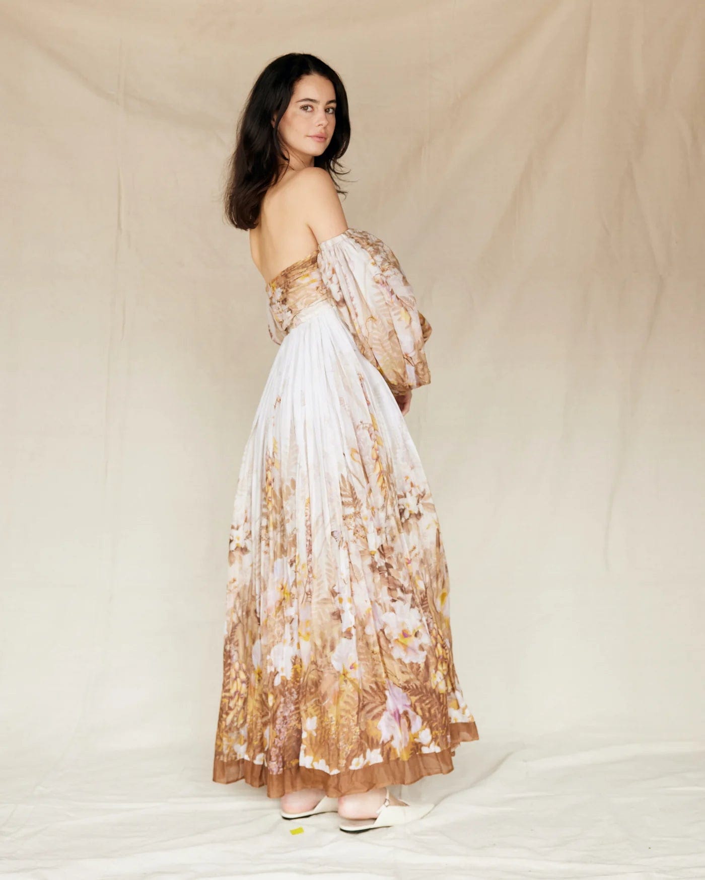 A pregnant lady wearing Everything Lace Hire Rooh Bronte Botanica Dress a brown floral dress during her maternity photoshoot