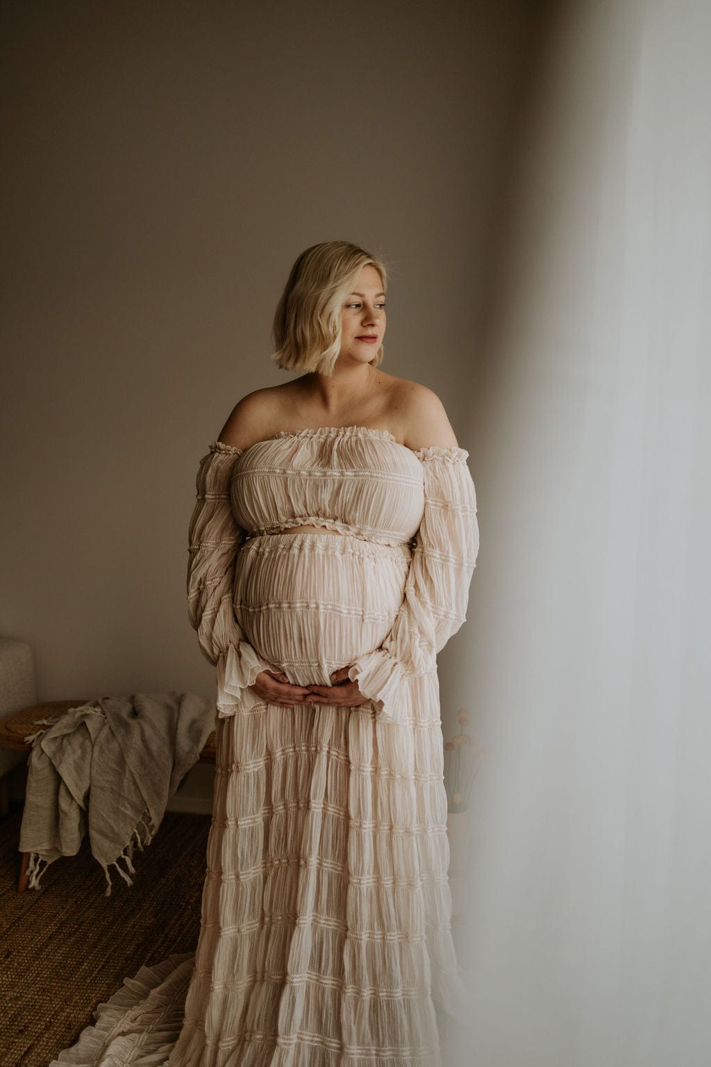 A pregnant lady wearing Everything Lace Hire Wonderful Moments Two Piece Photoshoot Set during her studio maternity photoshoot