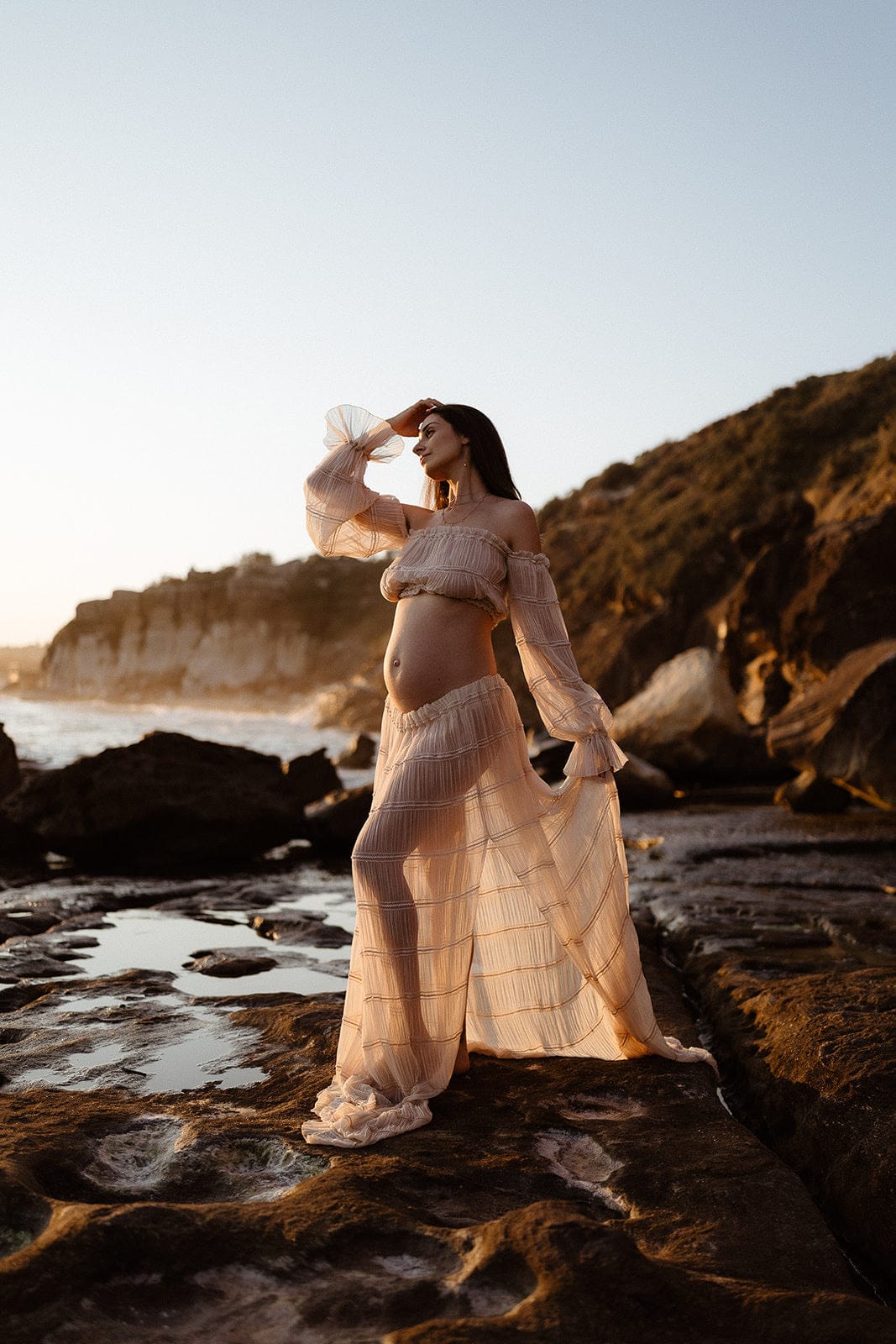 Pregnant woman posing in wonderful moments maternity outfit during her maternity photoshoot