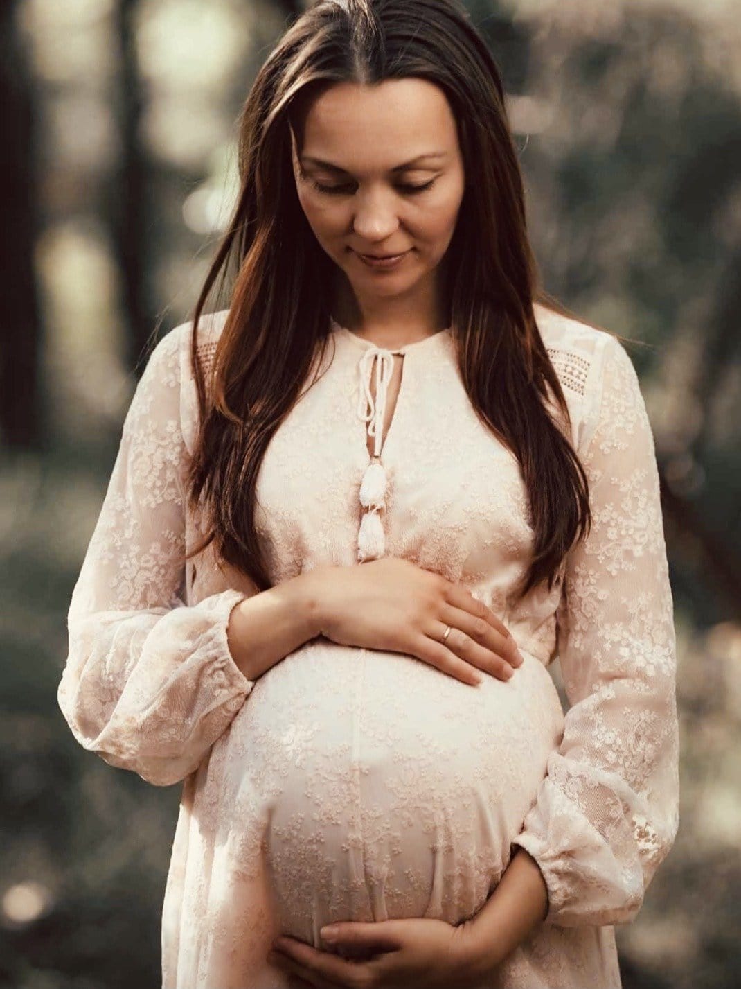 Pregnant lady wearing blush lace maternity dress