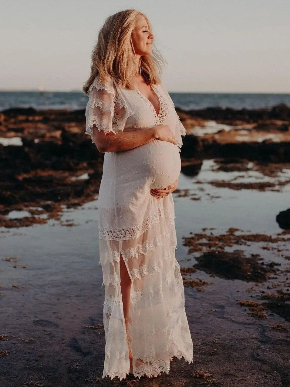 Pregnant mum in water wearing a boho white lace maternity dress